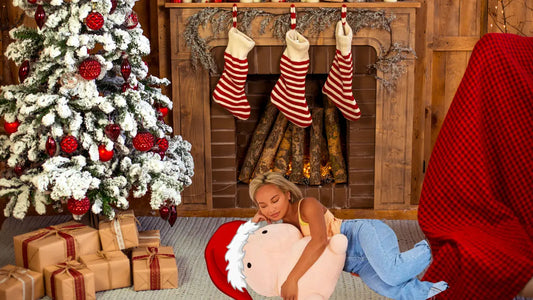 woman amd penis pillow snuggling by christmas trees