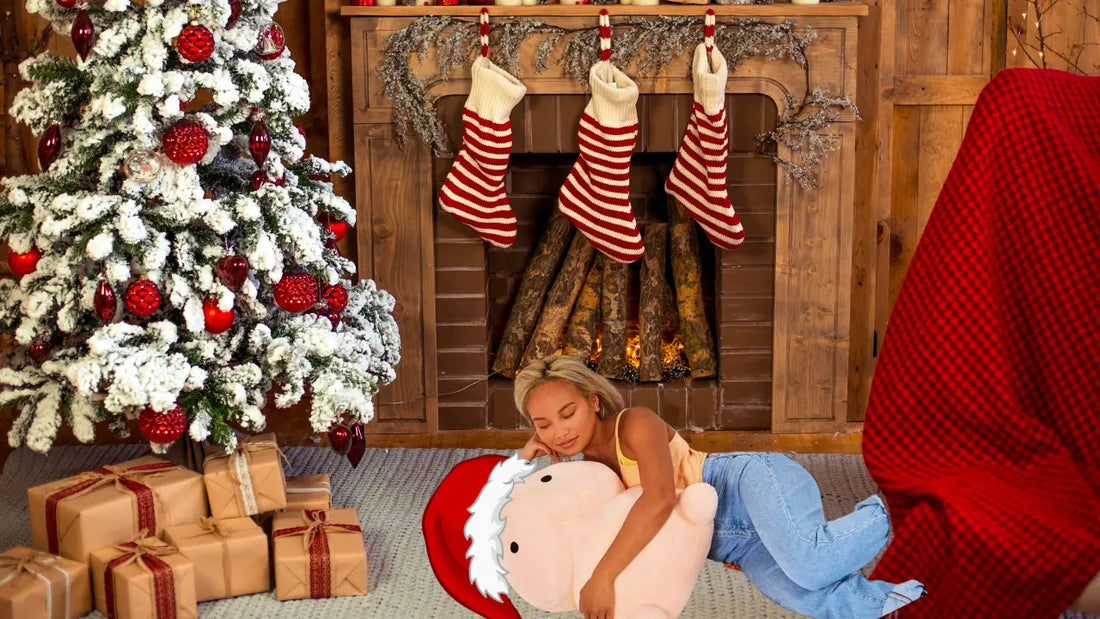 Pee Pee Pillow wearing santa hat snuggled with woman by Christmas Tree